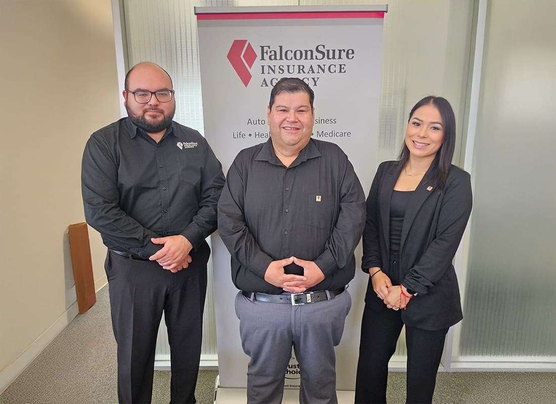 Eagle Pass, TX - Happy Team of Three Standing Outside of Their Office in Eagle Pass, TX Smiling an Looking Professional